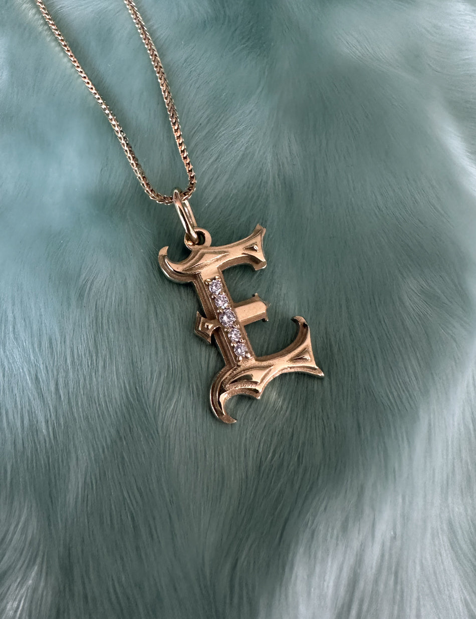 Gold Gothic Initial jewelry charm pendant with monogram "E" with diamonds by honey drip.