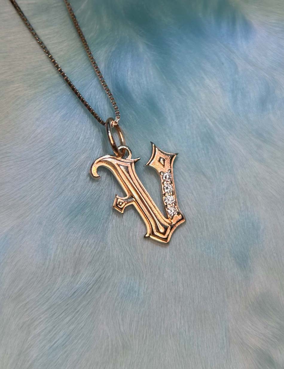 Gold Gothic Initial jewelry charm pendant with monogram "V" with diamonds by honey drip.