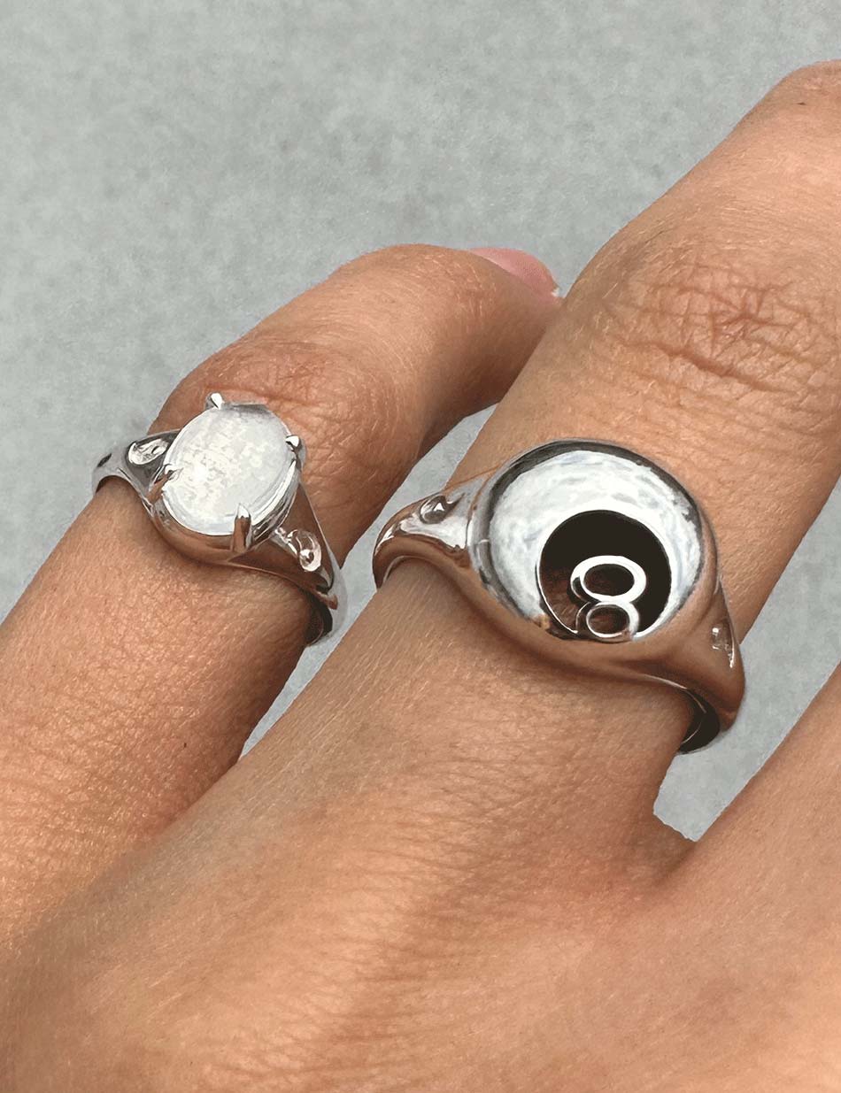 The Magic 8 Ball Billiards Signet Ring in silver and the Fortune Teller silver signet ring with quartz crystal by HONEY DRIP NYC