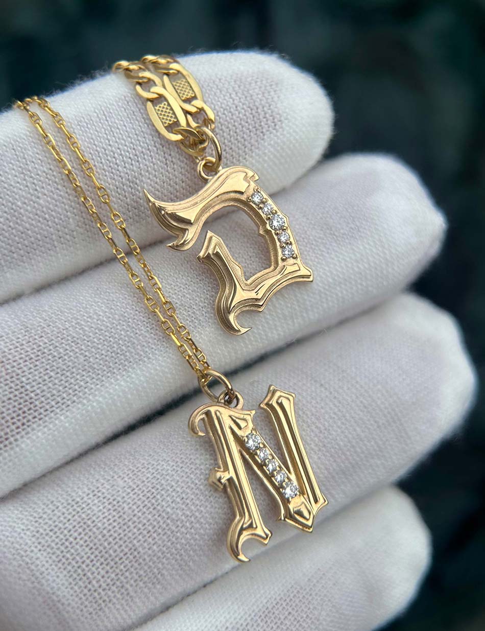 Gothic monogram "D" & "N" by Honey Drip Fine Jewelry, made in 14k gold & white diamonds.