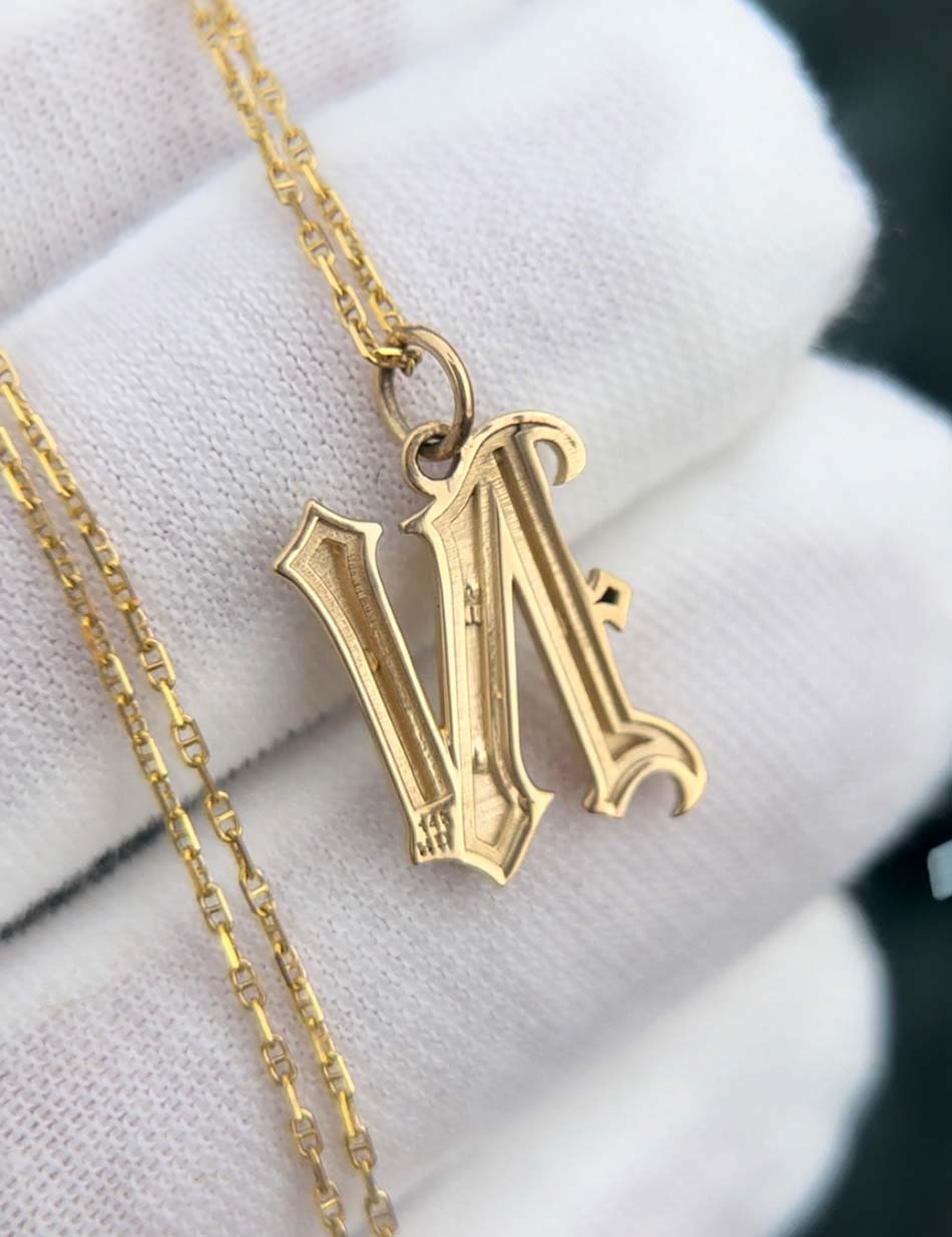 Backside of the Gothic monogram "N" charm pendant by Honey Drip Fine Jewelry.