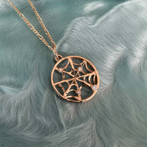 14k gold spider web charm pendant.