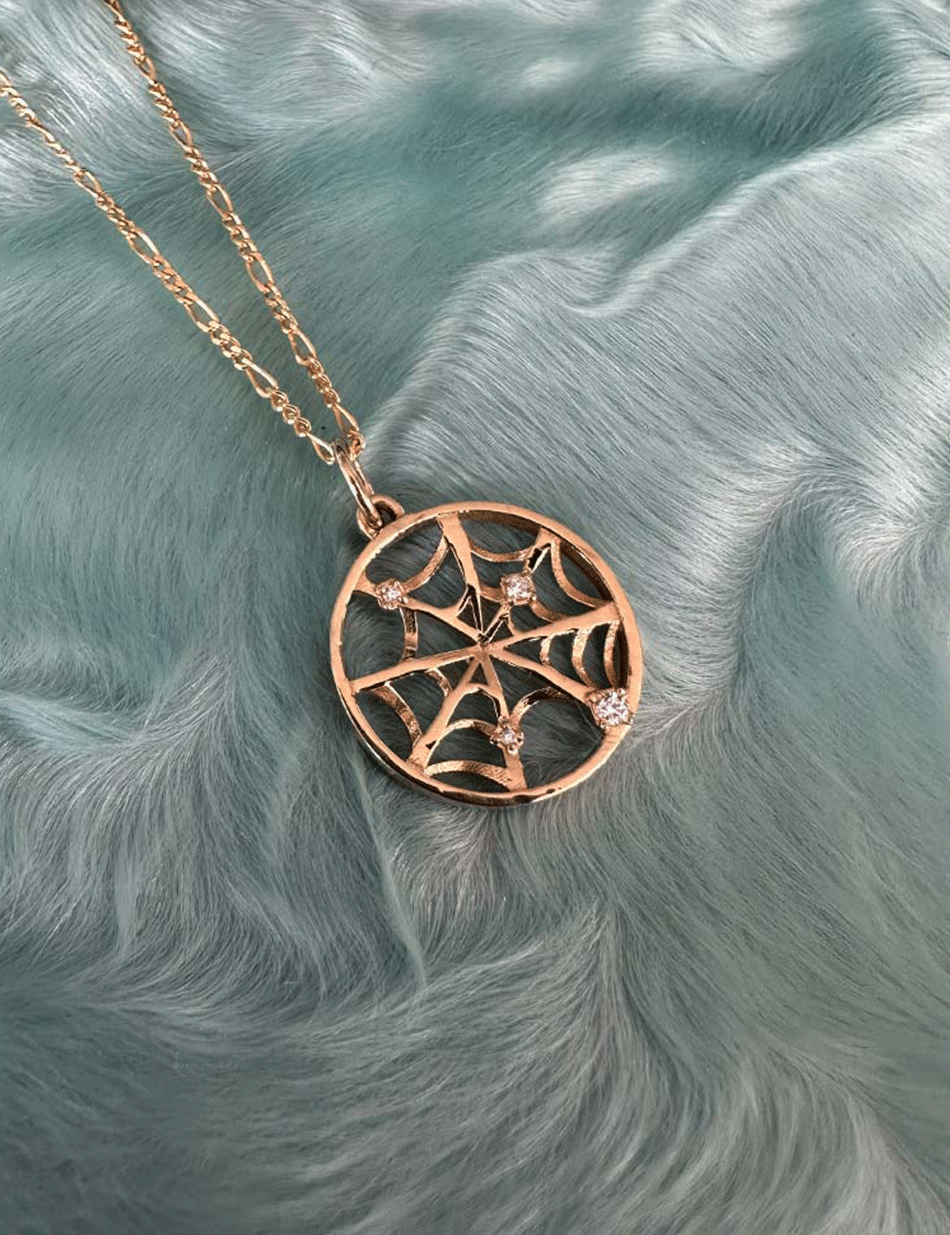 14k gold spider web charm pendant.