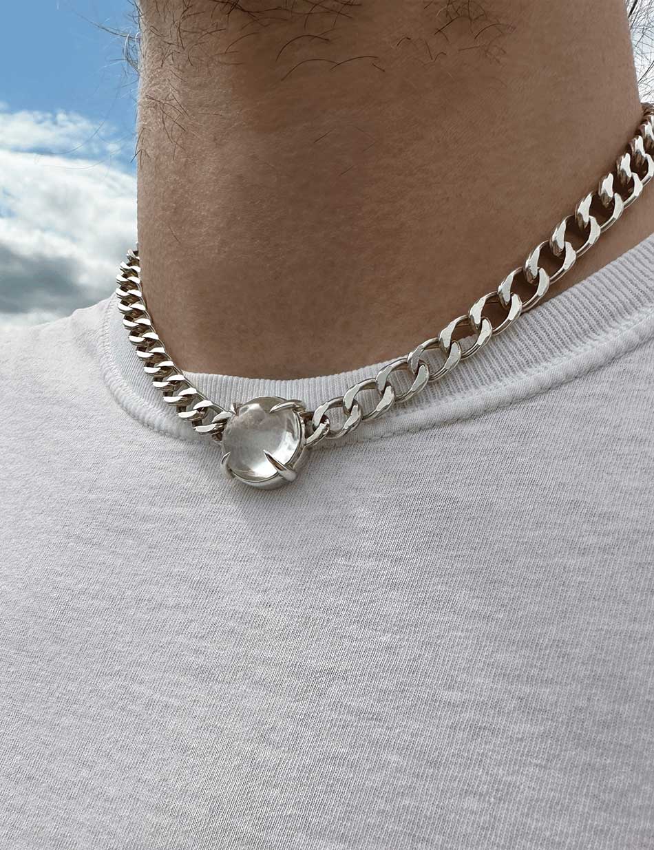 A close up of a man's neck wearing a white t shirt and the silver and quartz fortune teller collar choker by HONEY DRIP NYC