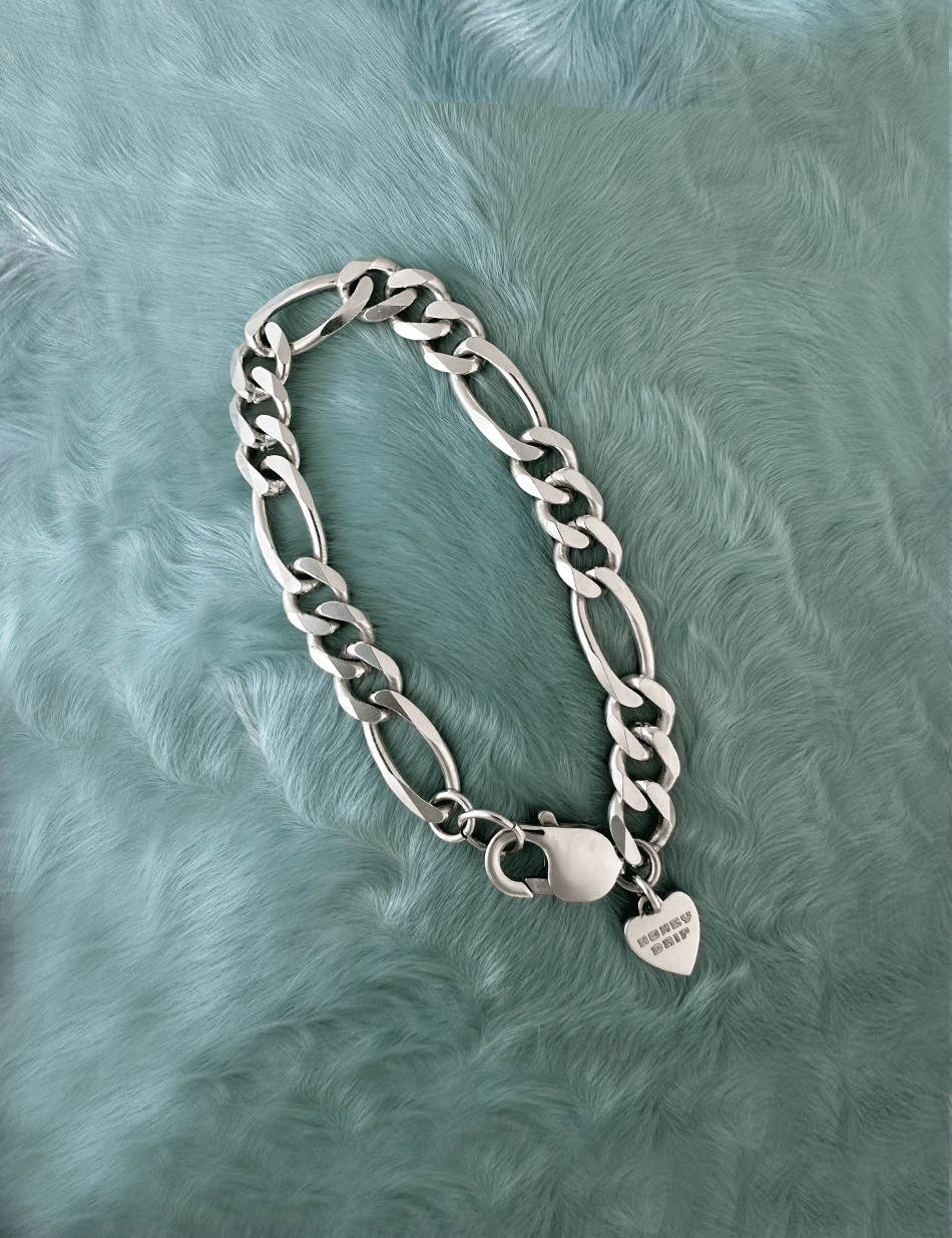 Silver Figaro chain bracelet by honey drip jewelry.