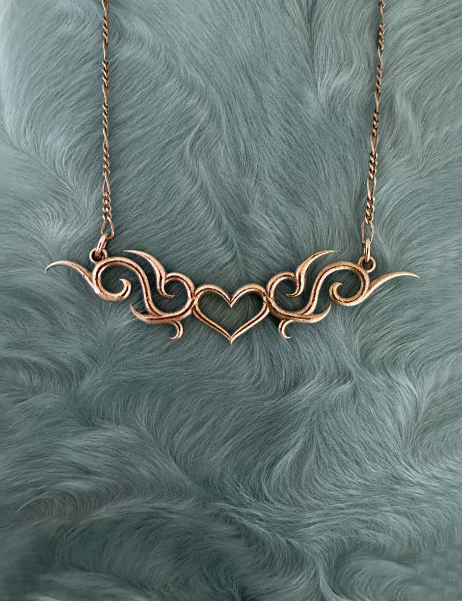 tramp stamp tribal heart necklace in 14k gold by honey drip jewelry