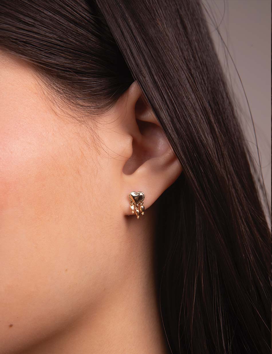 The bleeding sacred heart tassel stud earring by HONEY DRIP NYC in 14k gold.