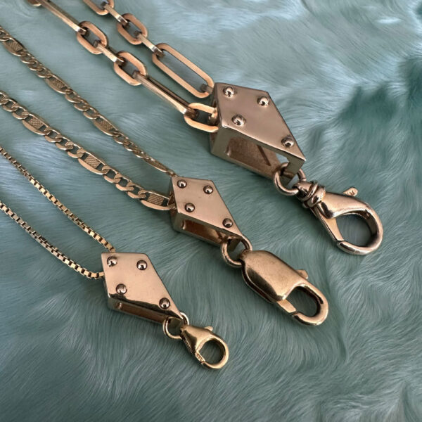 The one-of-a-kind stacking crane blocks in 14k gold with vintage clasps.